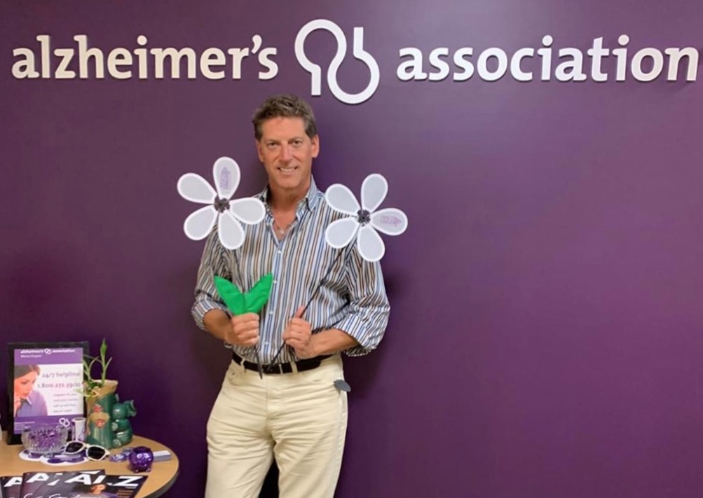 Shawn Shambo standing infront of alzheimers association